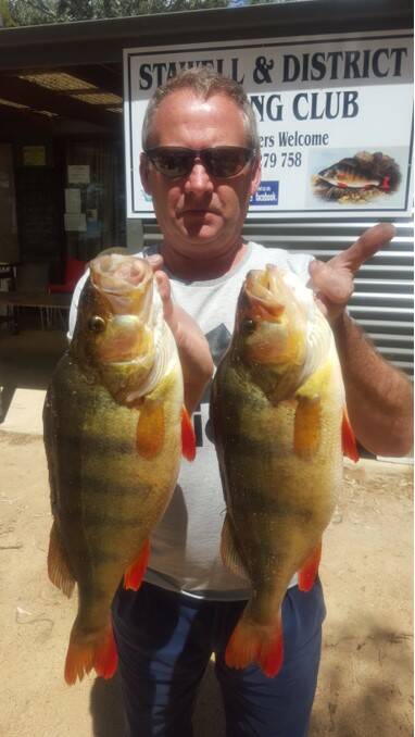 Nice catch: Darren Smith with his 45 and 44cm redfin.