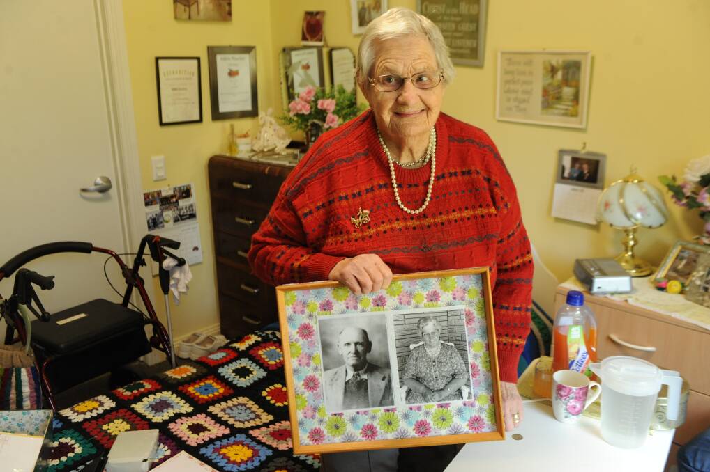 HISTORY: Adela Peucker holds a photo of her parents Christopher and Alma Cooper, the latter born on January 1, 1900. Picture: ALEXANDER DARLING
