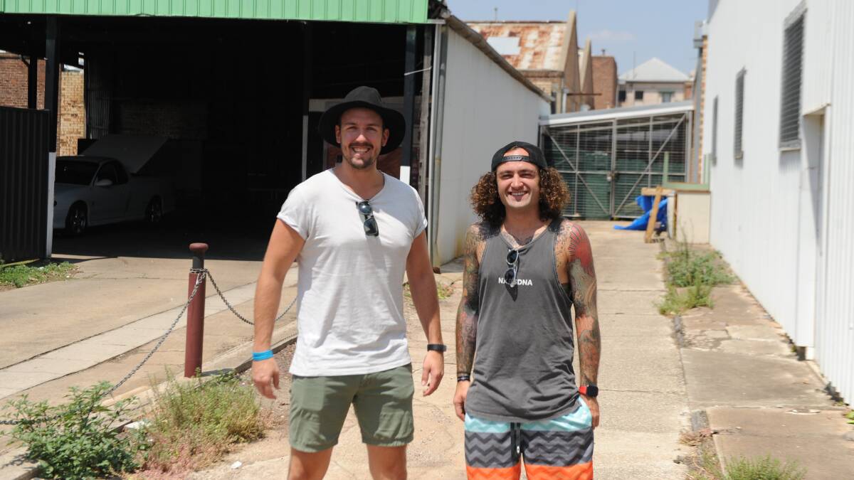 SOUNDS OF THE DRUMS BEATING IN THEIR HEARTS: Josh Young and Brady King outside the Exchange Hotel. The gate leading to 'The Room' is on the right. Picture: ALEXANDER DARLING