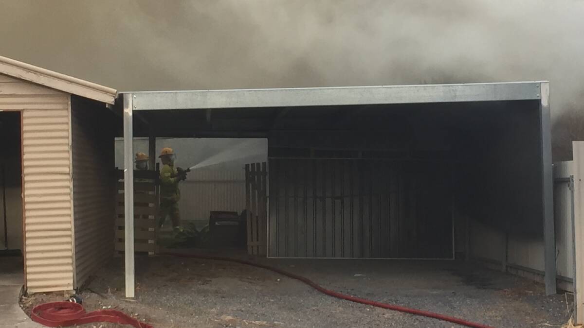CHECK YOUR CONNECTIONS, SAY FIREFIGHTERS: A CFA volunteer battles a blaze on Horsham's Olympic Street earlier this month. Picture: ALEXANDER DARLING