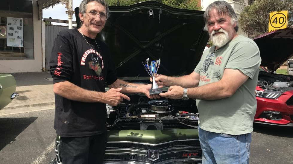 Minyip Show and Shine organiser Dale Maggs presents the people's choice award to Mildura's Butch Oliver at the 2018 event. Picture: CONTRIBUTED