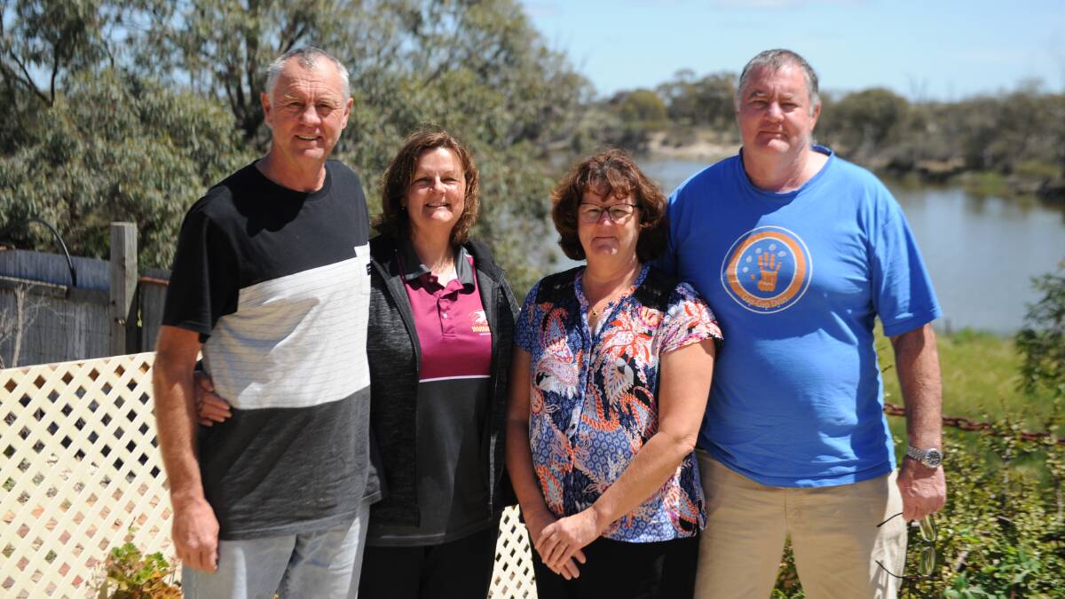 PROUD CHILDREN: Peter, Gaye, Tracey and Garry Livingston at their family home at the end of Upper Roy Street. Behind them is the Wimmera River, where father David loved to swim, and his vegetable garden. Picture: ALEXANDER DARLING