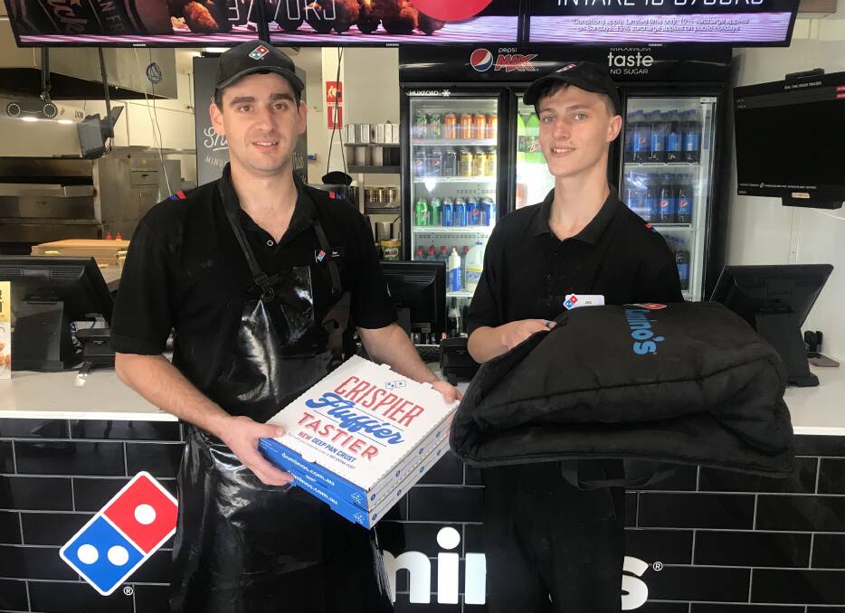 REACTION: Dominos Pizza Horsham workers Ben French and Zac Reichelt. The store is offering "contactless delivery". Picture: TAYLOR PADFIELD