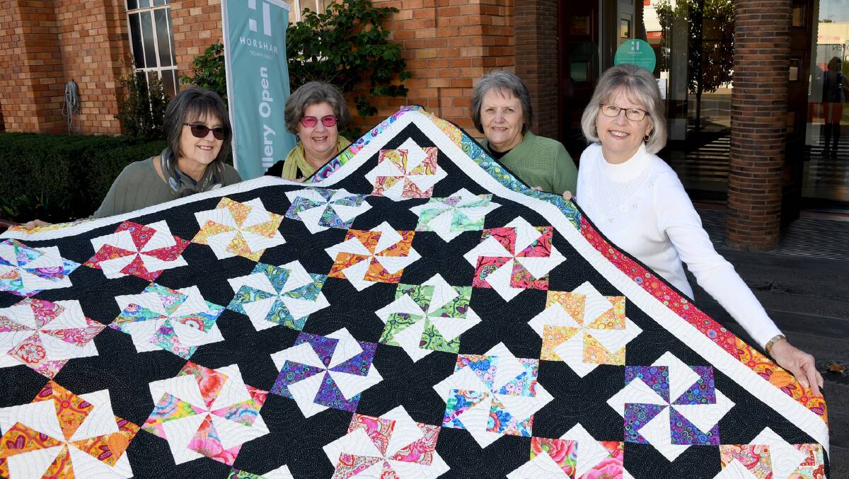 FRUITS OF THEIR LABOR: Heather Brennan, Jeanette Hardman, Sandra Douglas and Rebecca Grieger, with the Twirling Stars quilt for the Horsham Patchwork and Quilters 2019 exhibition. Picture: SAMANTHA CAMARRI