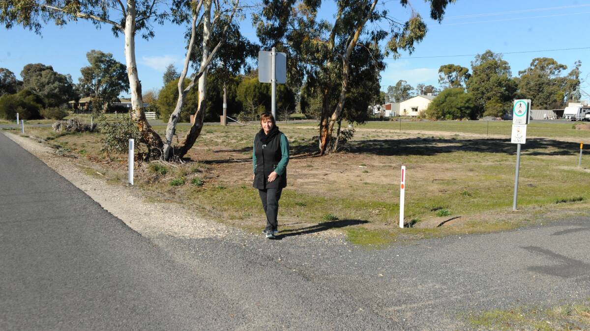 Mrs Exell at the intersection of hunts Road and the Henty Highway. A bike path runs alongside the latter.