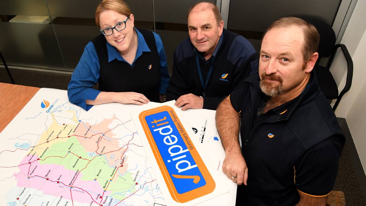 KEY ROLES: GWMWater Wimmera Mallee Pipeline's quality manager Anne Rudge, land liaison officer Kel Sleep, and GIS specialist Stephan Le Rouxwith a map of the plan. Picture: SAMANTHA CAMARRI