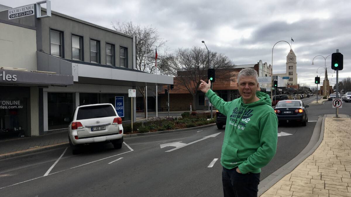 Paul Atherton gesture towards the top floor of a CBD building. It is ones like these Business Horsham would like to explore the suitability of to become living premises. Picture: ALEXANDER DARLING