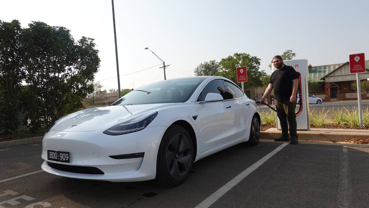 ELECTRIC DREAMS: Andrew Frahn filling up his Tesla Model 3 in Dubbo. picture: CONTRIBUTED