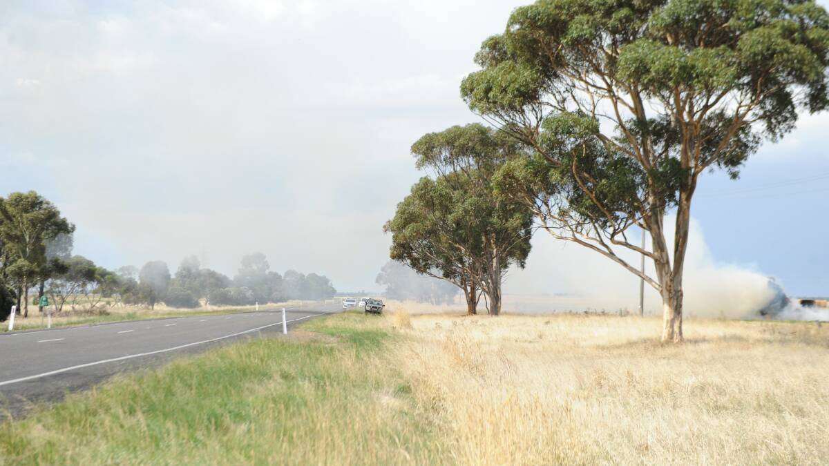 SMOKY: A haystack fire in a paddock near the Henty Highway at Jung. Picture: ALEXANDER DARLING