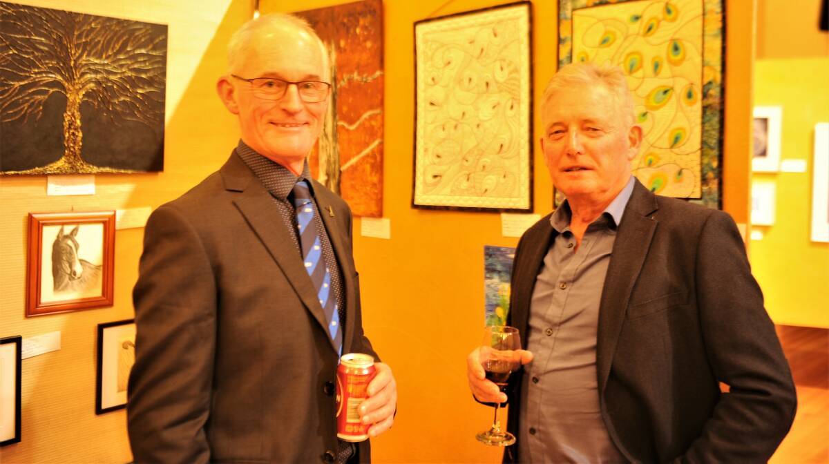 PERUSING: Rotary club member Jim Delahunty with Gordon McKenry check out works by Horsham's multimedia artists.