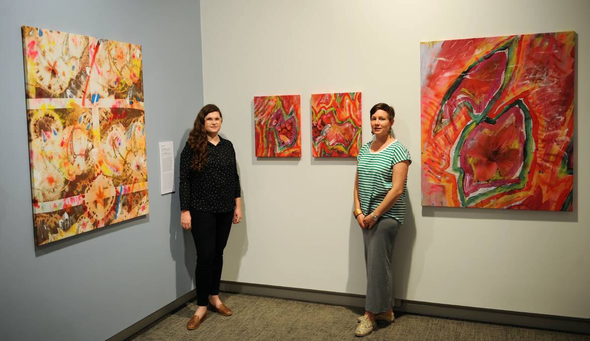 GET CREATIVE: Horsham Art Gallery curator Michelle Mountain (left) and education officer Faith Hardman (right) with artist Minna Gilligan's works on display. Ms Gilligan will hold a workshop for VCE students next Friday.