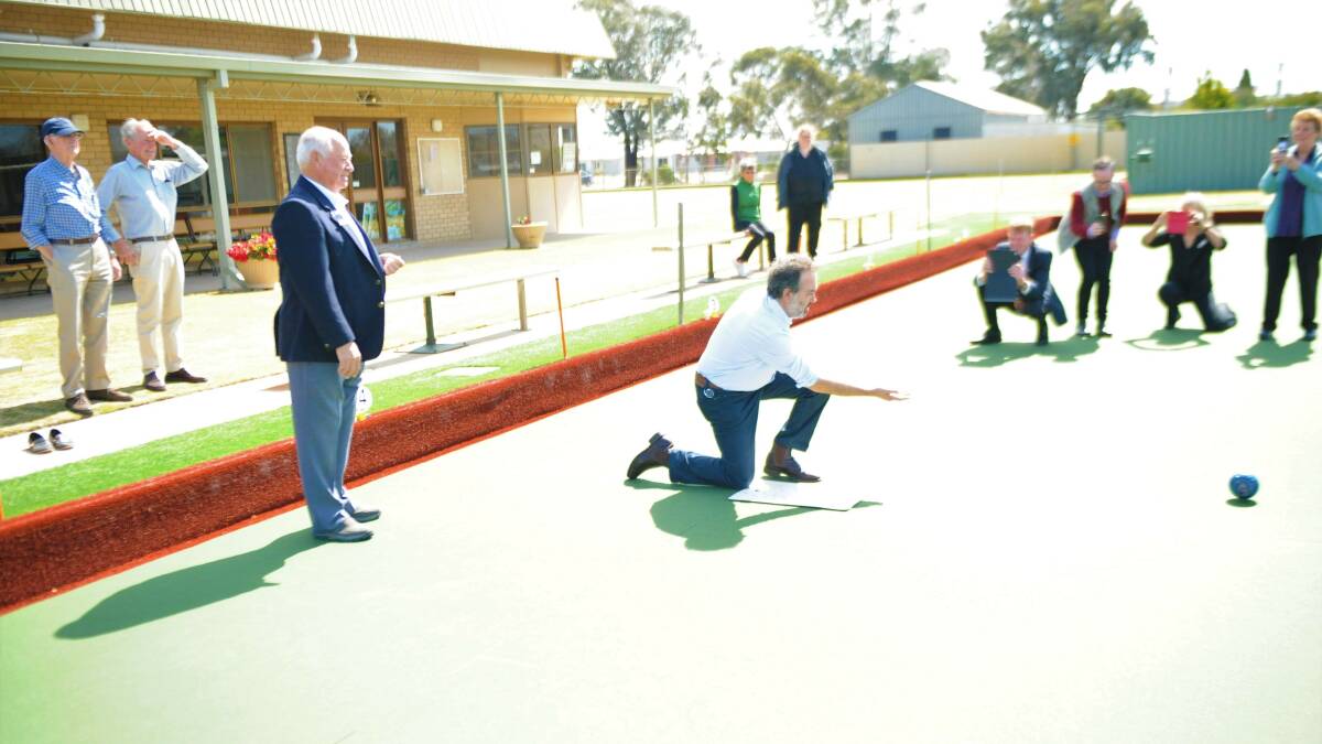 FUNDING WELCOMED: Sport, Tourism and Major Events Minister Martin Pakula tries his luck on Horsham City Bowling Club's new synthetic green as club president Stewart Landwehr watches. Picture: ALEXANDER DARLING