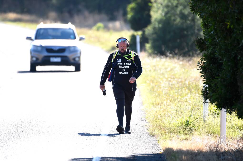 DETERMINED: A focused Alan Thorpe as he walks along the Western Highway from Ballarat to Adelaide. Picture: FILE