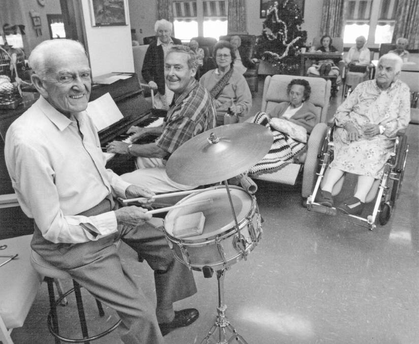 1997: Les Smith (front) and Ron Hammond entertaining residents in the Menzies Nursing Home. Picture: HHS 008065