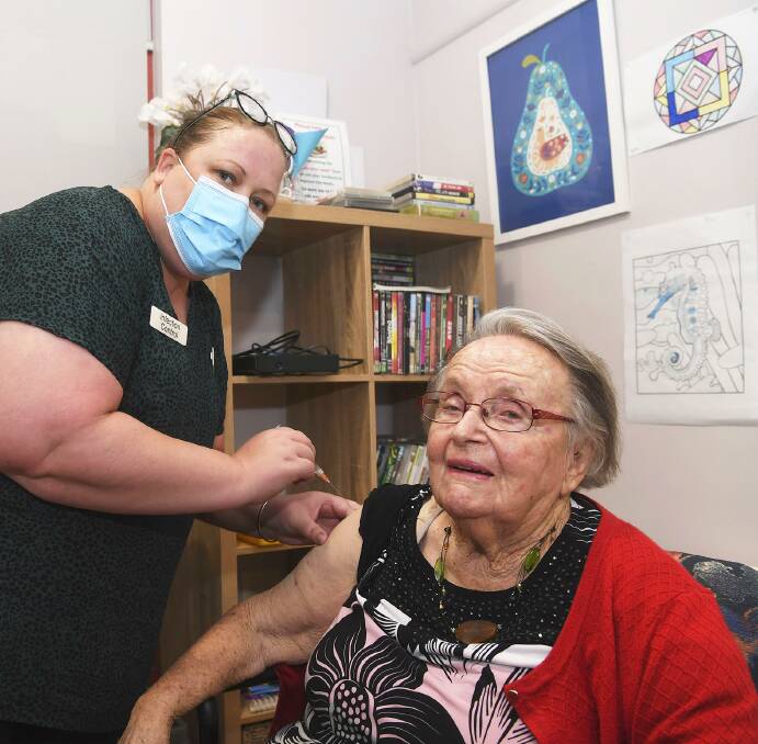 LANDMARK MOMENT: Wimmera Health Care Group infection control coordinator Rachel Baker administers Audrey Merrett's vaccination. It was the first COVID-19 vaccination in Horsham. Picture: PAUL CARRACHER