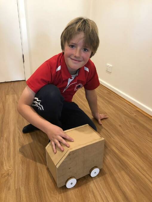 ALL SMILES: Frances Primary School student Gus Sambell proudly displays the wooden truck he built from his pack donated by Bordertown cabinet maker Jordan Brown. Photo: Supplied.
