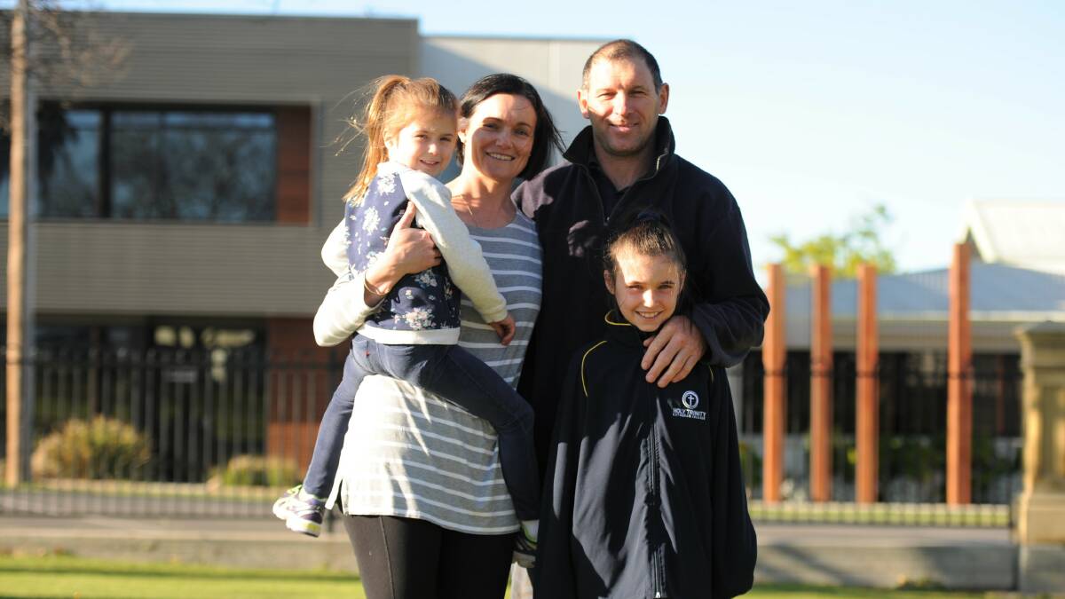 PROUD: Gavin Kelm with his youngest daughter Maggie, wife Zeena and older daughter Pippa. Picture: MATT CURRILL