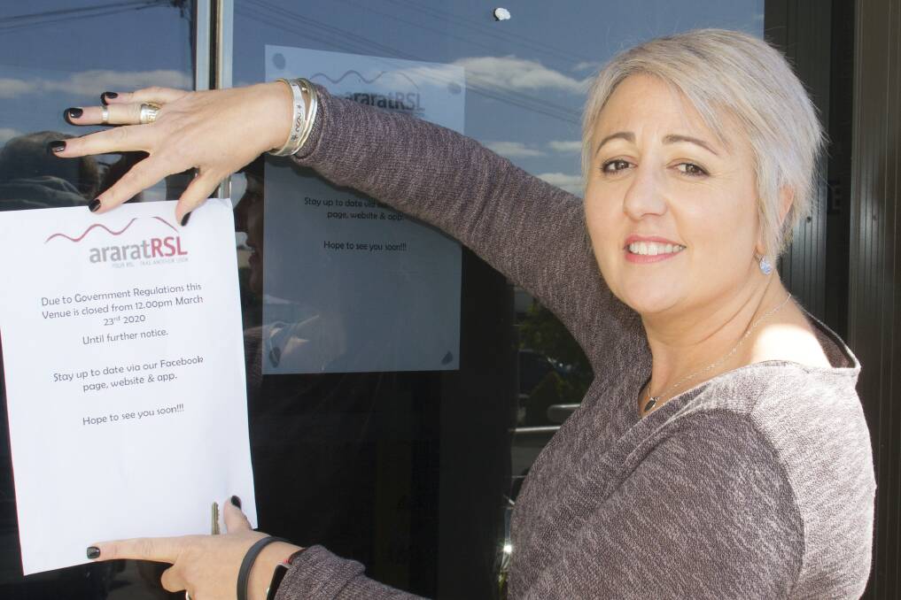 CLOSED: Greater Ararat Business Network president and Ararat RSL manager Maria Whitford puts up a closed sign. 
