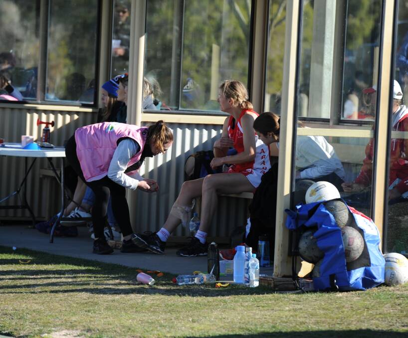 STRAPPING: An Ararat trainer straps ice to Megan Shea's calf muscle after she picked up an injury in the round 17 game against Horsham. Picture: MATT CURRILL