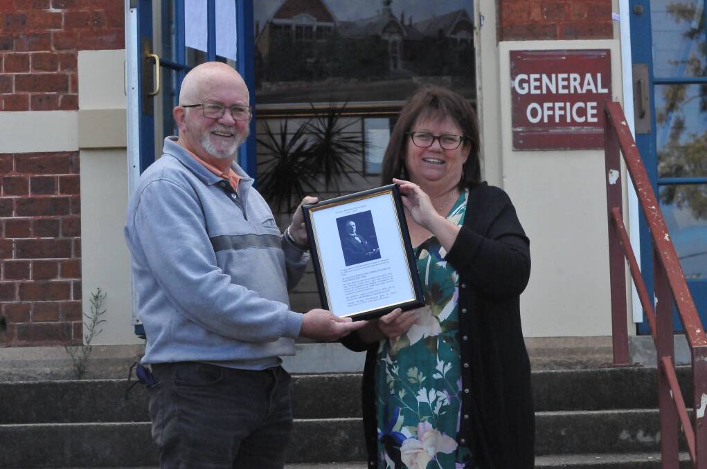 ETCHED IN HISTORY: Stawell Historical Society's Greg Robson presents Stawell 502 Primary School principal Robyn Jones with a historical piece on George Predergast. Picture: CASSANDRA LANGLEY