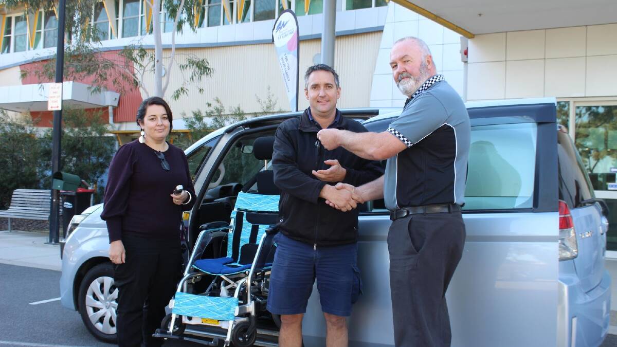 Grampians Community Health's program leader customer engagement Kristy Price with program leader information and assests Luke Bibby recive the keys to the new car from Grampians Toy Club's Jamie Erwin.