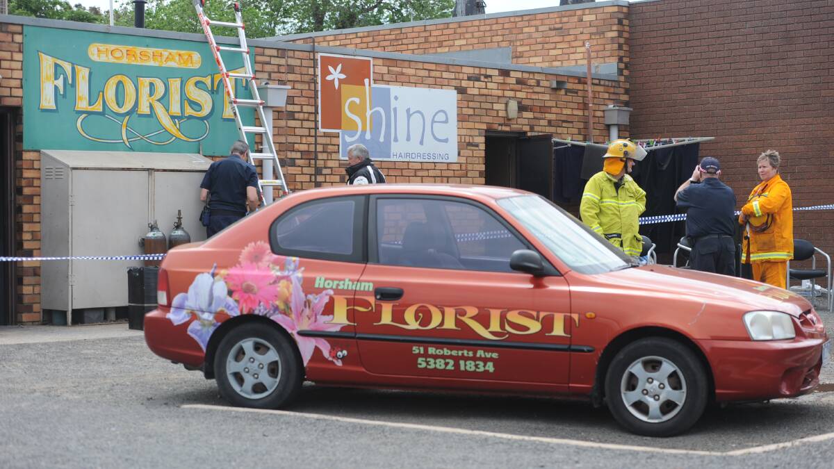 Police and CFA outside the back of Horsham Florist on Saturday morning. Picture: SEAN WALES