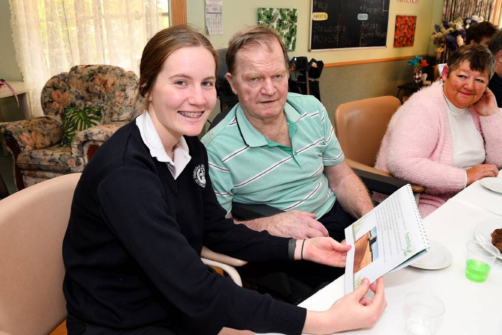 SCHOOL PROJECT: Dimboola Memorial Secondary College student Sophie Warner reading a lifebook with Allambi resident Graeme Bond. Picture: SAMANTHA CAMARRI