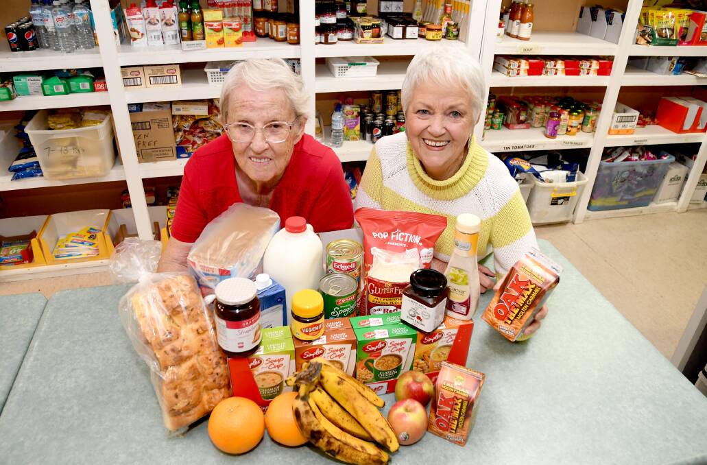 HELPING HAND: Horsham's Christian Emergency Food Centre volunteers Florence Webb and Anne Mahony are happy to have helped the community for 20 years. Picture: SAMANTHA CAMARRI
