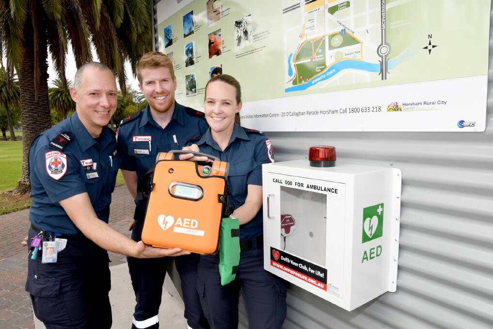 NEWLY INSTALLED: Ambulance Victoria's Paul Burton, James Morse and Emma Clark with a new defibrillator. Picture: SAMANTHA CAMARRI
