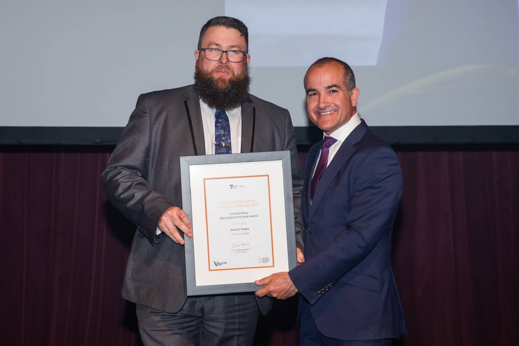 WINNER: Horsham College principal Rob Pyers accepting the secondary principal of the year award from Education Minister James Merlino at the Victorian Education Excellence Awards. Picture: CONTRIBUTED 
