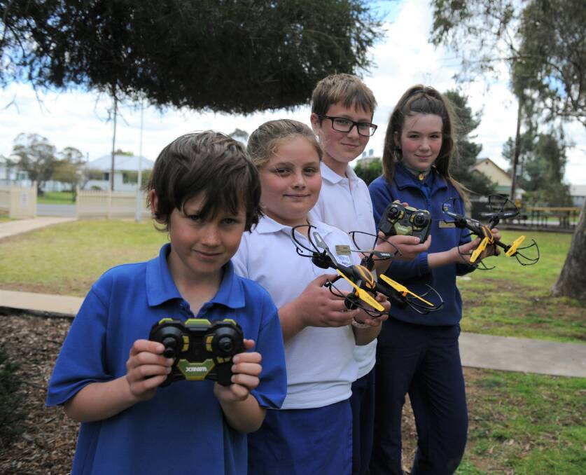 SOARING: Minyip Primary School students Jarvis Mitchell, Rory Starick, Will Hotker and Charlotte Maher with the school's brand new drones. Picture: DAINA OLIVER