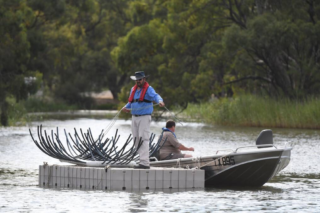 BOOST: Wimmera CMA's Bruce McInnes and Rivertech's Steve Talbot are submerging structures to create new habitats for fish in the Wimmera River. Picture: Samantha Camarri