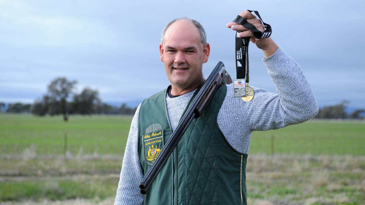 PROUD: Ashley Bolwell wearing his vest from the 2008 Glenn Cup and holds medals from his time shooting for Australia. Picture: ELIJAH MACCHIA