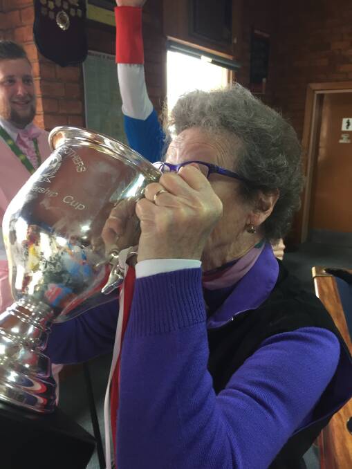Gay Fischer drinking from the Taylors Lake reserves 2016 premiership cup.  