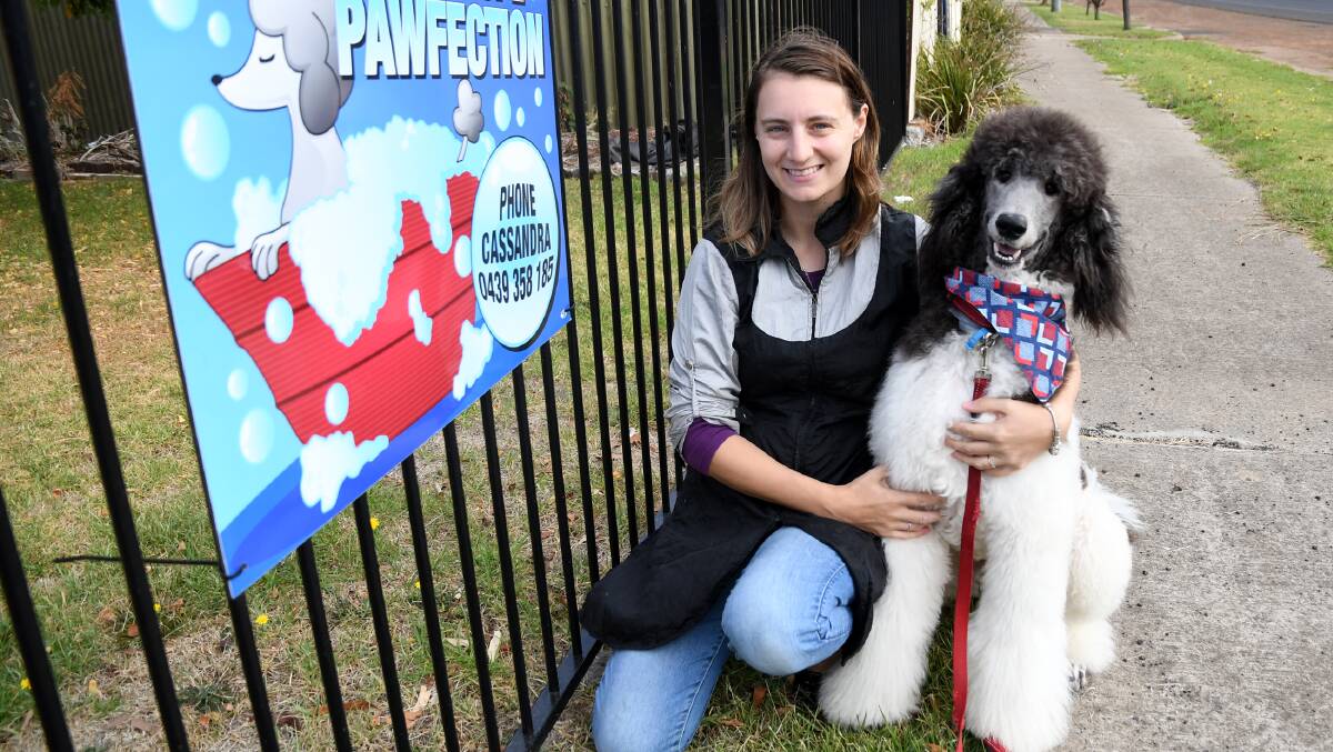 MAN'S BEST FRIEND: Edenhope's Cassie Stringer and her puppy Enzo out the front of her new business, Edenhope Pawfection. Picture: SAMANTHA CAMARRI