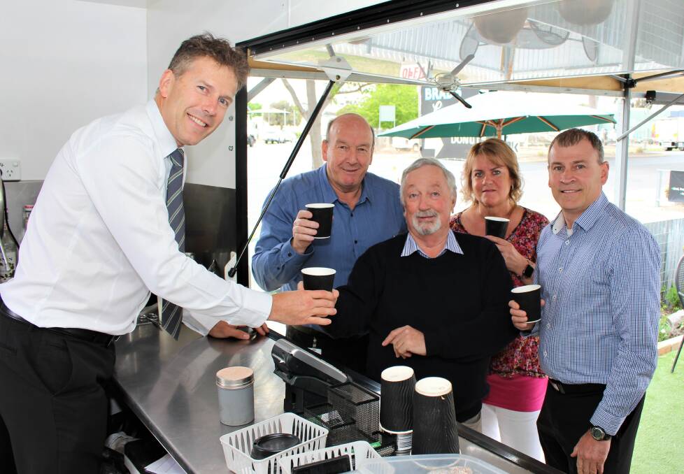 FEEL GOOD BREW: Robert Goudie gives a coffee to Wimmera Health Care Group Foundation chairman Graeme Hardman watched by Peter Miller, Christine Chapple and Richard Goudie. Picture: CONTRIBUTED
