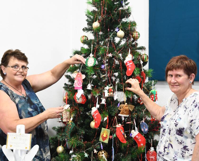 FEELING FESTIVE: Tricia Arber and Elizabeth Minne decorating the Christmas tree at The Makers' Gallery and Studio for their All Things Christmassy display. Picture: ELIZA BERLAGE
