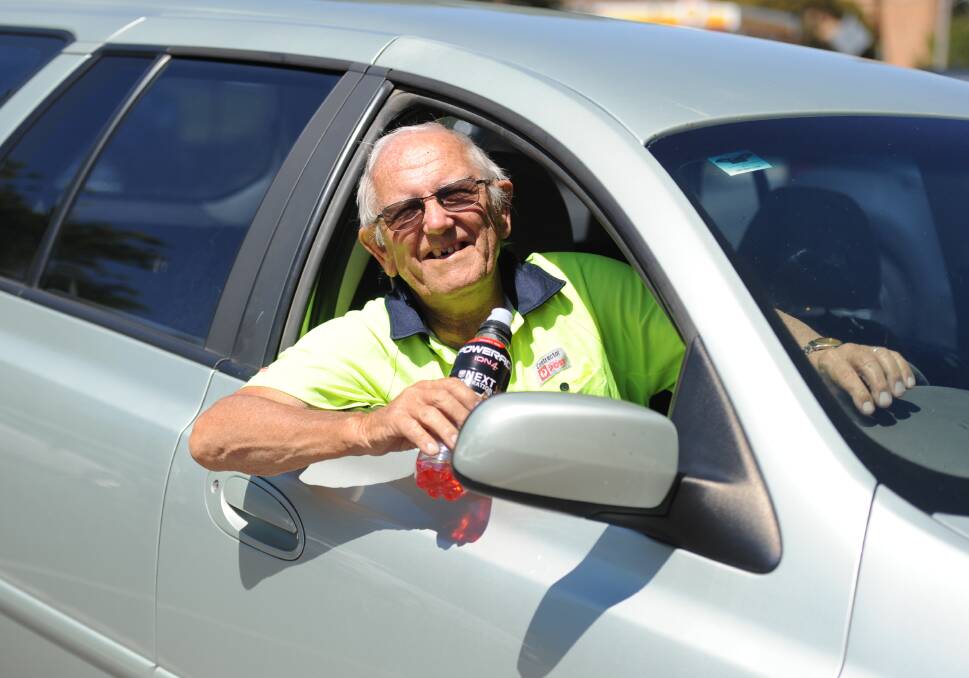 STAYING COOL: Australia Post contractor Mick Darnell keeps the air conditioner running in his car and a bottle of Powderade handy on hot days. Picture: ELIZA BERLAGE