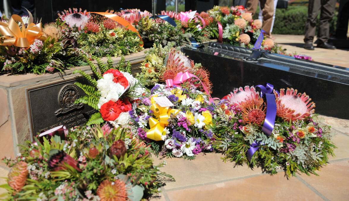 LEST WE FORGET: Flowers laid at the Horsham Remembrance Day service in 2018. Picture: JADE BATE