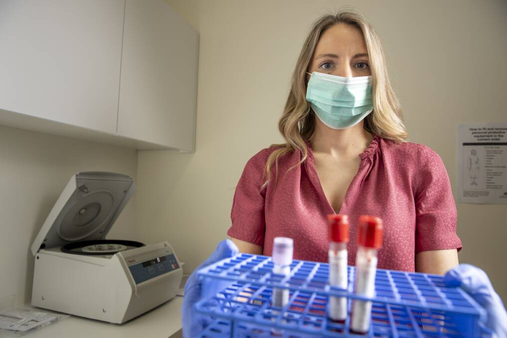 Paratus Clinical Research site manager Ashlee Innes prepares blood samples to be sent for testing. Picture: Sitthixay Ditthavong 