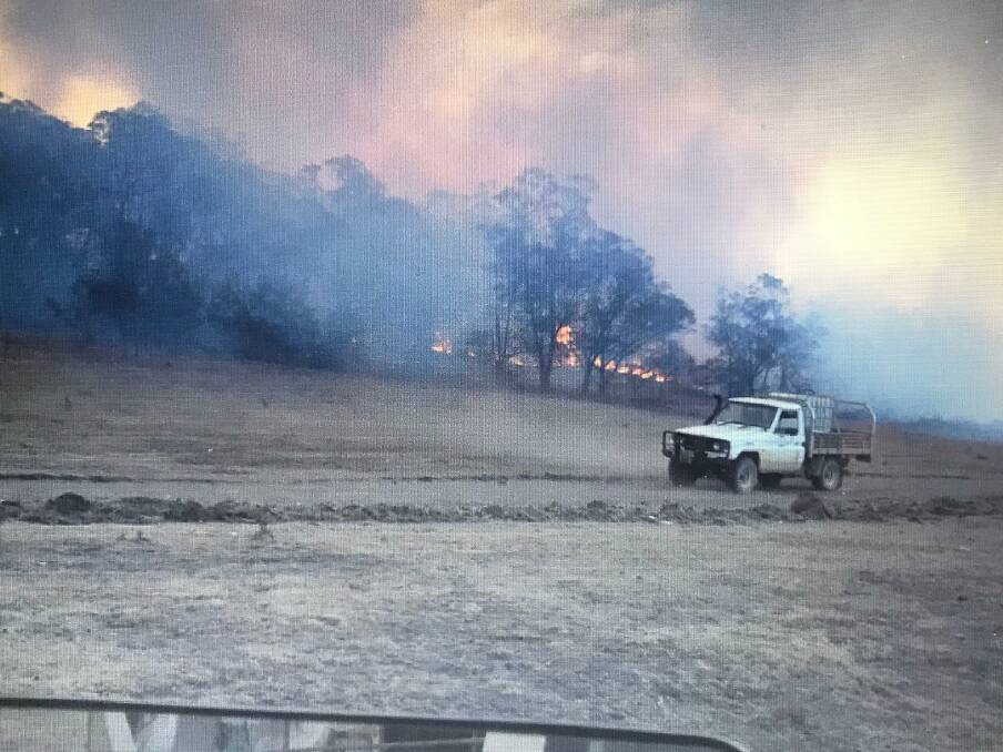 A property owner patrolling the containment line as the firefront approaches. Picture: Robbie Wallace