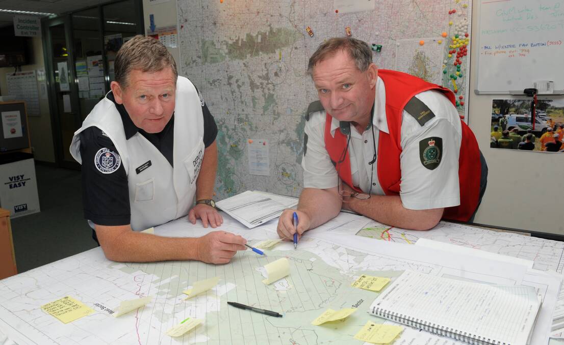 Dale Russell, left, in the Horsham Incident Control Centre with Mal Gibson in January 2014. Picture: SAMANTHA CAMARRI