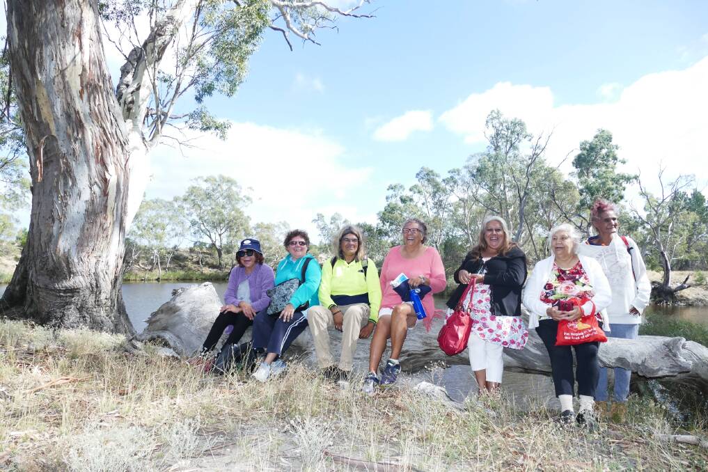 Heather Marks, Belinda Marks, Sharnie Hamilton, Hazel McDonald, Noelene Douglas, Faye Marks and Sandra Knight take a moment to relax by the Wimmera River in Dimboola during River Yarns last year. Immersive heritage specialist, virtual historian and artist Brett Leavy used information gathered on the tour to create the game Virtual River Yarns. Picture: CONTRIBUTED