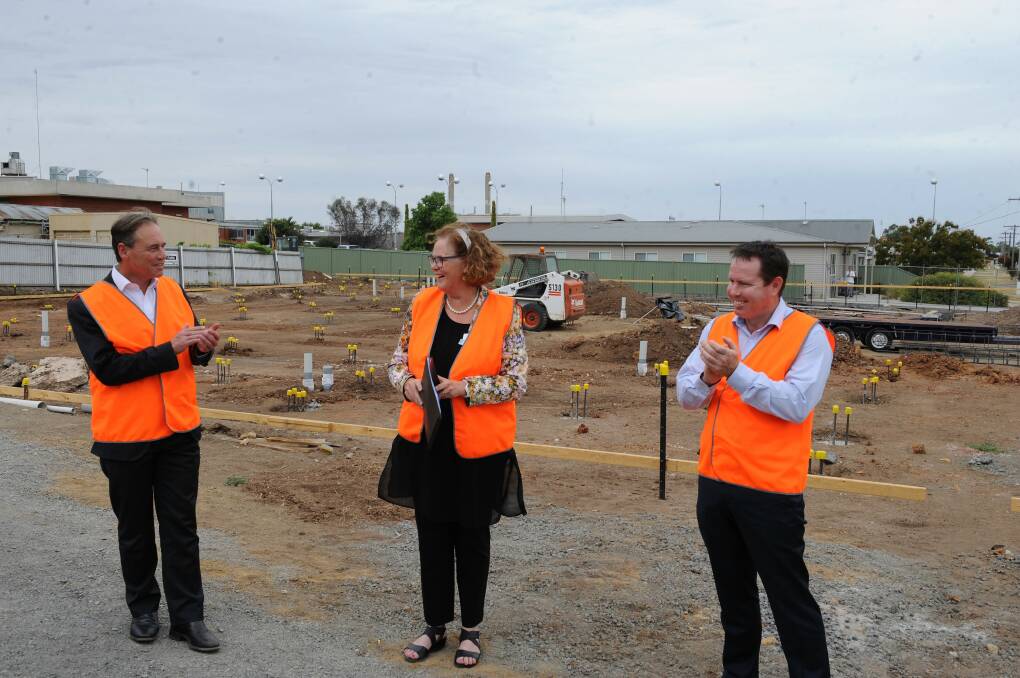 Federal Health Minister Greg Hunt and Member for Mallee Andrew Broad applaud Wimmera Health Care Group board chairwoman Marie Aitken at the Wimmera Cancer Centre site last week. Picture: CARLY WERNER