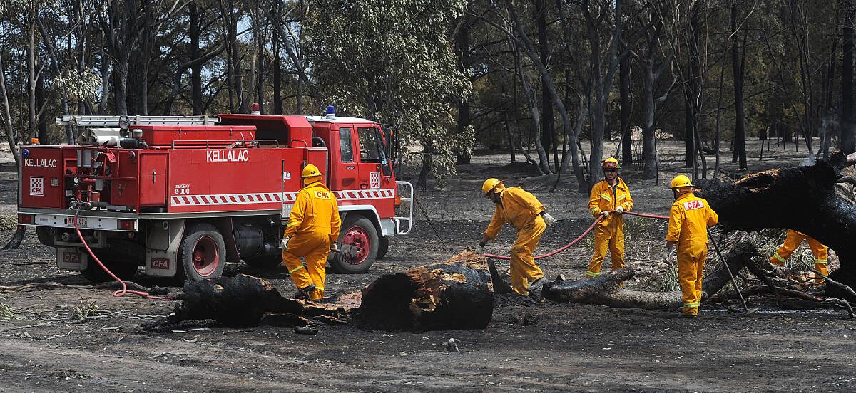 BLACK DAY: Firefighters work near Plozzas Road, Haven, after the Remlaw fire on February 7, 2009. 