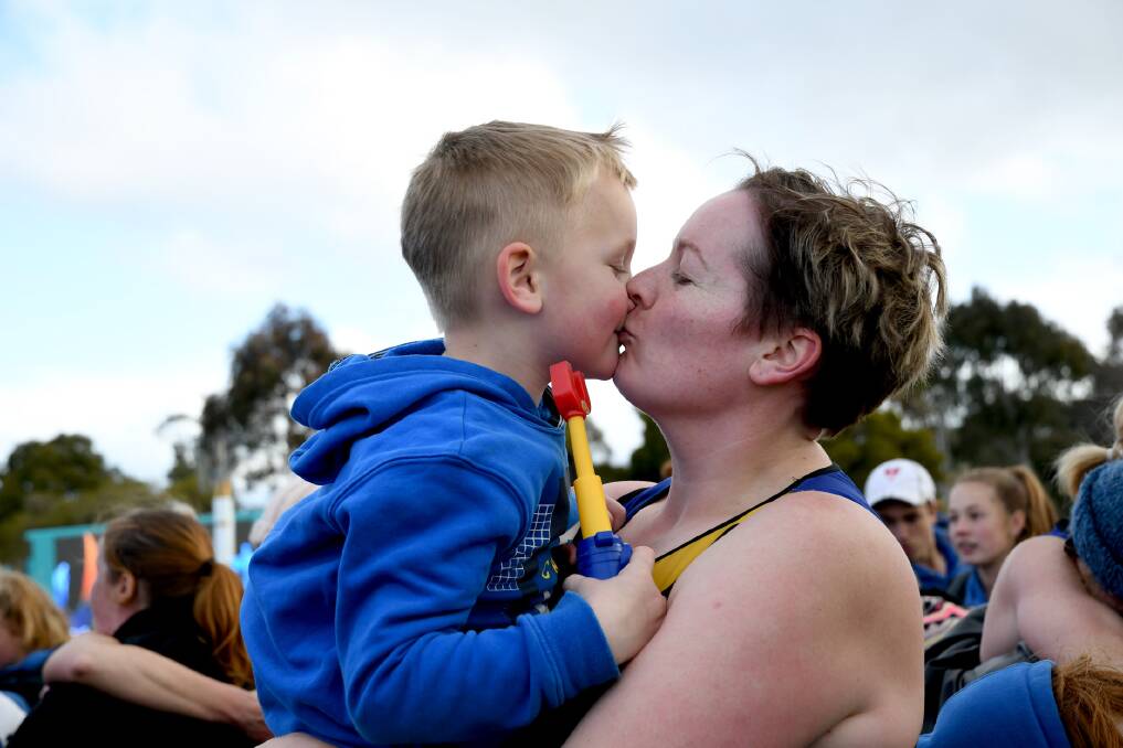 Natimuk United goal shooter Shannon Couch kisses her son after winning the A Grade premiership. Picture: SAMANTHA CAMARRI