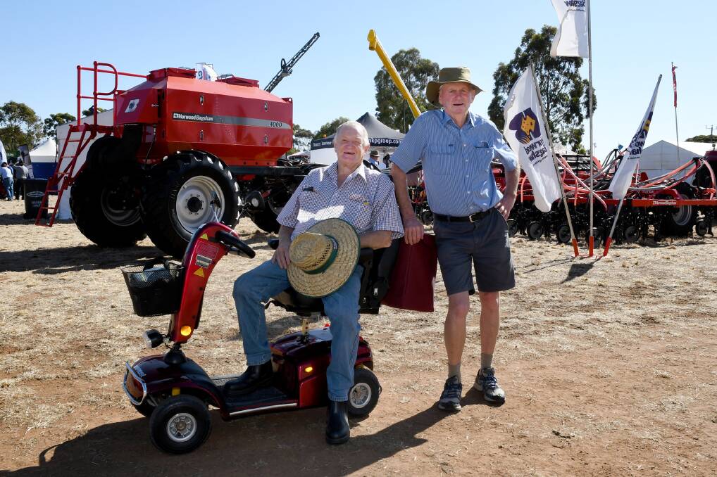 Ken Irwin, St Arnaud, and Garry Knights, Drouin, enjoy a catch-up at the field days. Picture: SAMANTHA CAMARRI