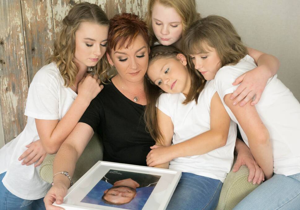 THE HARDEST GOODBYE: Trudi Weir and her daughters with a photo of their husband and father Jason. Picture: BELLA MADRE