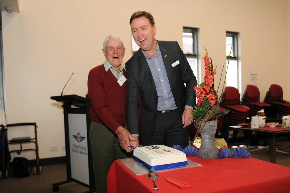 MILESTONE: Allen Webb, 96, of Horsham helps the Royal Flying Doctor Service's Rob Armour cut a cake on Thursday to celebrate 90 years of the organisation. Picture: STUART MCGUCKIN