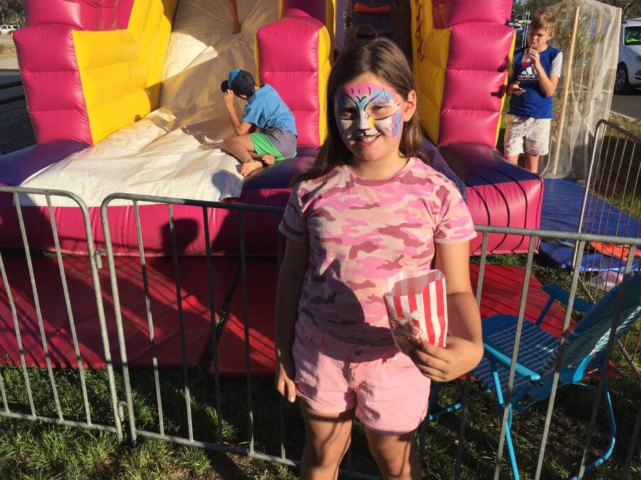 PRETTY IN PINK: Ella Cossans enjoys some of the children's activities on offer at the cup. Picture: JESSIEANNE GARTLAN